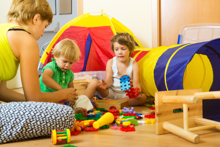 Young mother and children playing with toys in home: Delays in autism diagnosis threaten ‘breakthrough’ PACT treatment